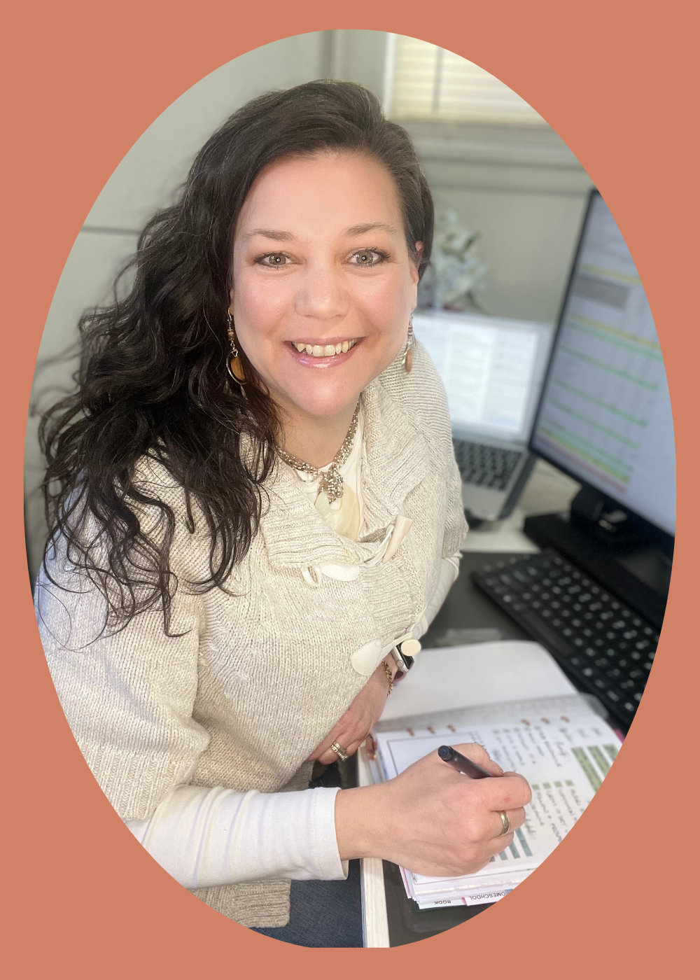 Christy, mom of a 15 year old autistic son, sits at her desk with her planner in front of her. She has long, brown, wavy hair and is wearing a beige sweater.